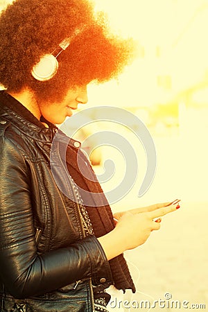 Young woman with afro hair cut and headphones