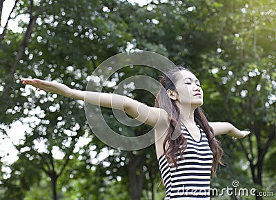 Young woman arms raised enjoying the fresh air