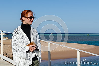 Young woman at the beach on a cold day