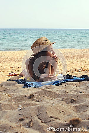 Young Woman on the Beach wearing a Straw Hat