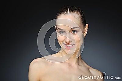 Young woman with beautiful healthy face - dark background