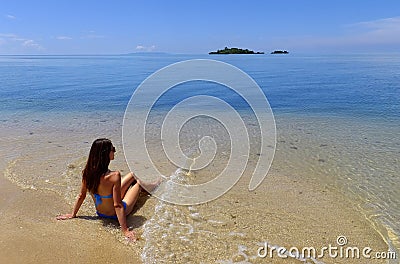 Young woman in bikini sitting on a beach, Vanua Levu island, Fij