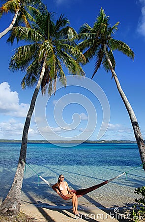 Young woman in bikini sitting in a hammock