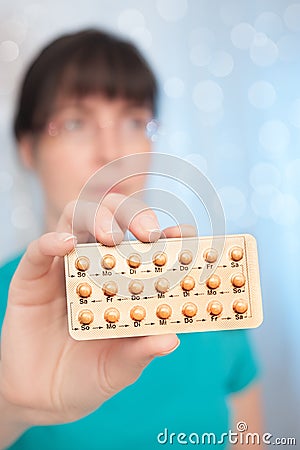 Young woman with birth control pills