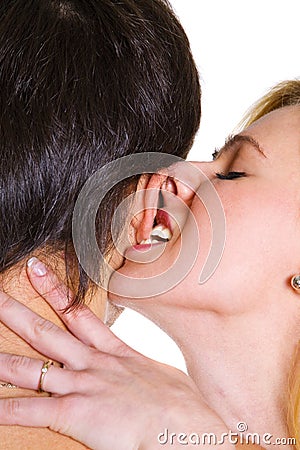 Young woman biting young man ear.