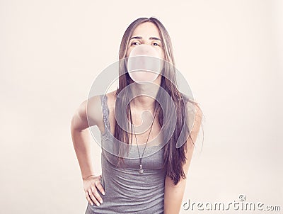 Young woman blowing a bubble gum