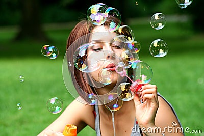 Young woman blowing bubbles