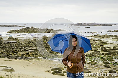 Young woman with blue umbrella