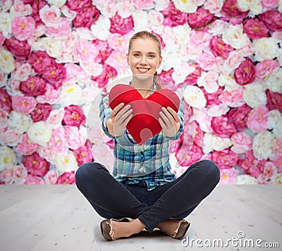 Young woman in casual clothes sitting on floor