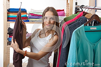 Young woman chooses clothes