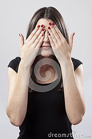 Young woman covering eyes