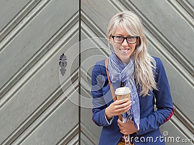 Young woman with cup of coffee outdoors.