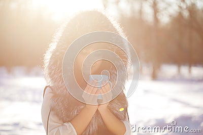 Young woman with a cup of hot drink