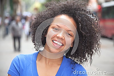 Young woman with curly hair in the city