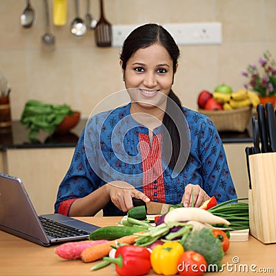 Young woman cutting vegetables
