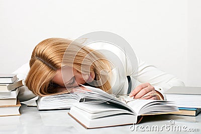 Young woman falling asleep while studying