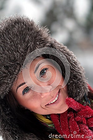 Young woman in fur hat face close up on the snow