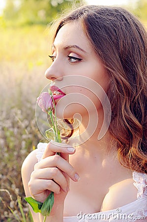 Young woman gathering herbs in the field