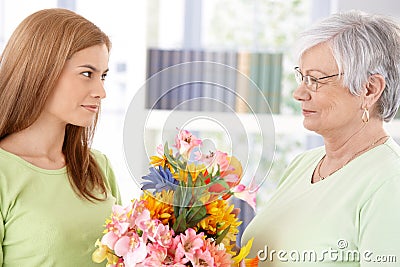 Young woman greeting mother at mother s day