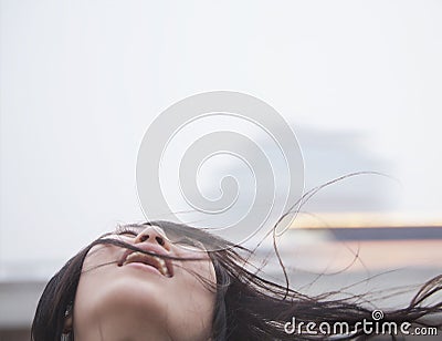 Young woman with hair blowing