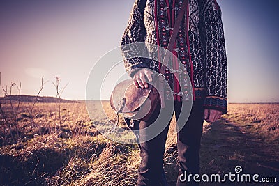 Young woman with handbag standing on nature trail