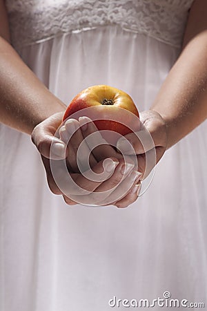 Young woman hands holding an apple