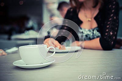 Young woman having coffee and cake