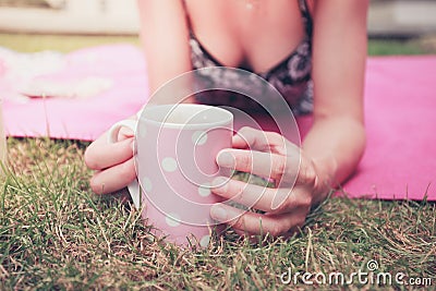 Young woman having tea outside