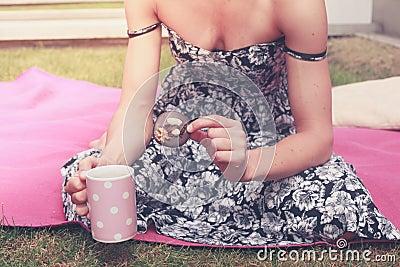 Young woman having tea outside