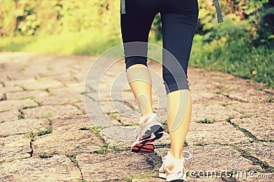 Young woman hiker feet walking rural trail