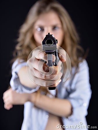 Young woman holding a gun