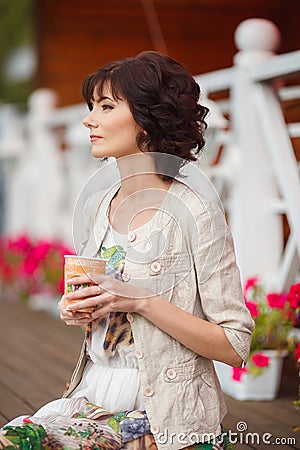 Young woman holding a paper cup and smiling