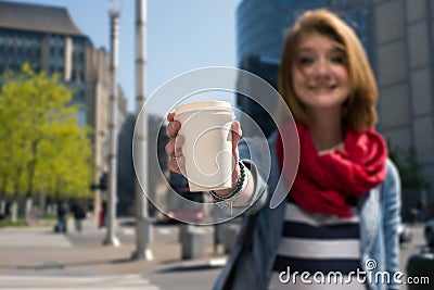 Young woman holding a paper cup and smiling