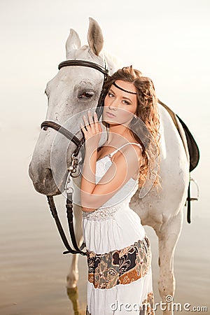 Young woman on a horse. Horseback rider, woman riding horse on b