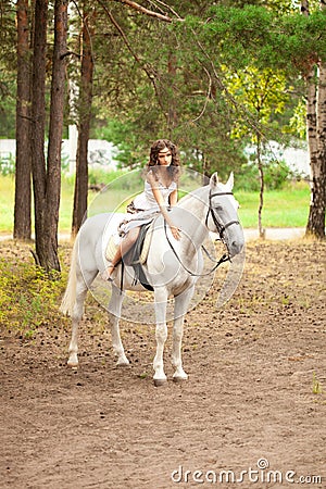 Young woman on a horse. Horseback rider, woman riding horse