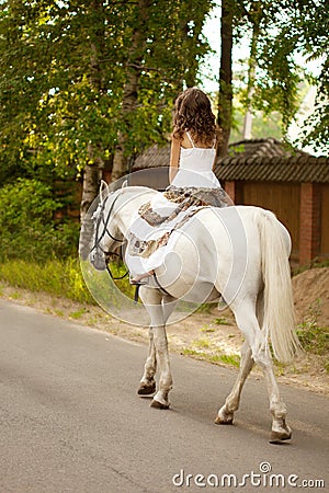 Young woman on a horse. Horseback rider, woman riding horse