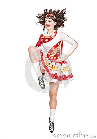 Young woman in irish dance dress dancing isolated