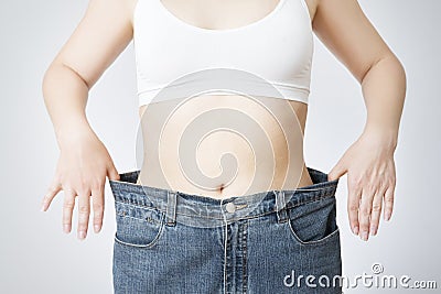 Young woman in jeans of large size, concept of weight loss