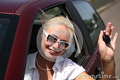 Young woman with keys in the car