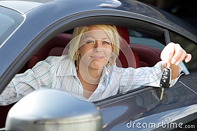 Young woman with keys of new, hire or rental car