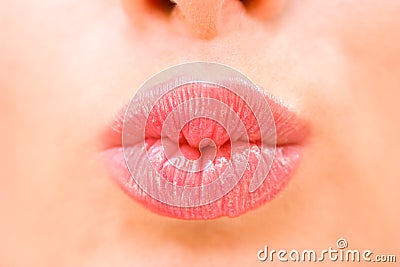 Young woman kissing lips