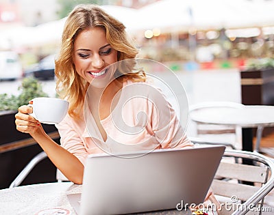 Young woman with laptop outdoors