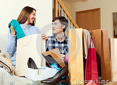 Young woman and man shopaholic with clothes