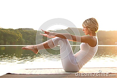 Young woman meditating on the beach