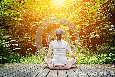 Young woman meditating in a forest. Zen, meditation, healthy breathing