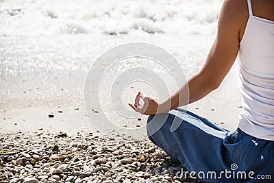 Young woman meditation on the beach