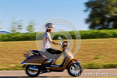 Young woman on a motor scooter