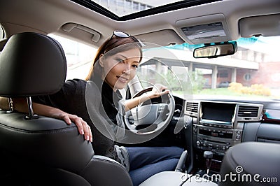 Young woman in the new car