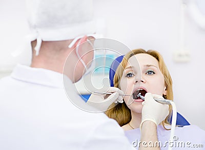 Young woman with open mouth during drilling treatm