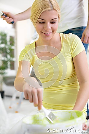 Young woman painting home